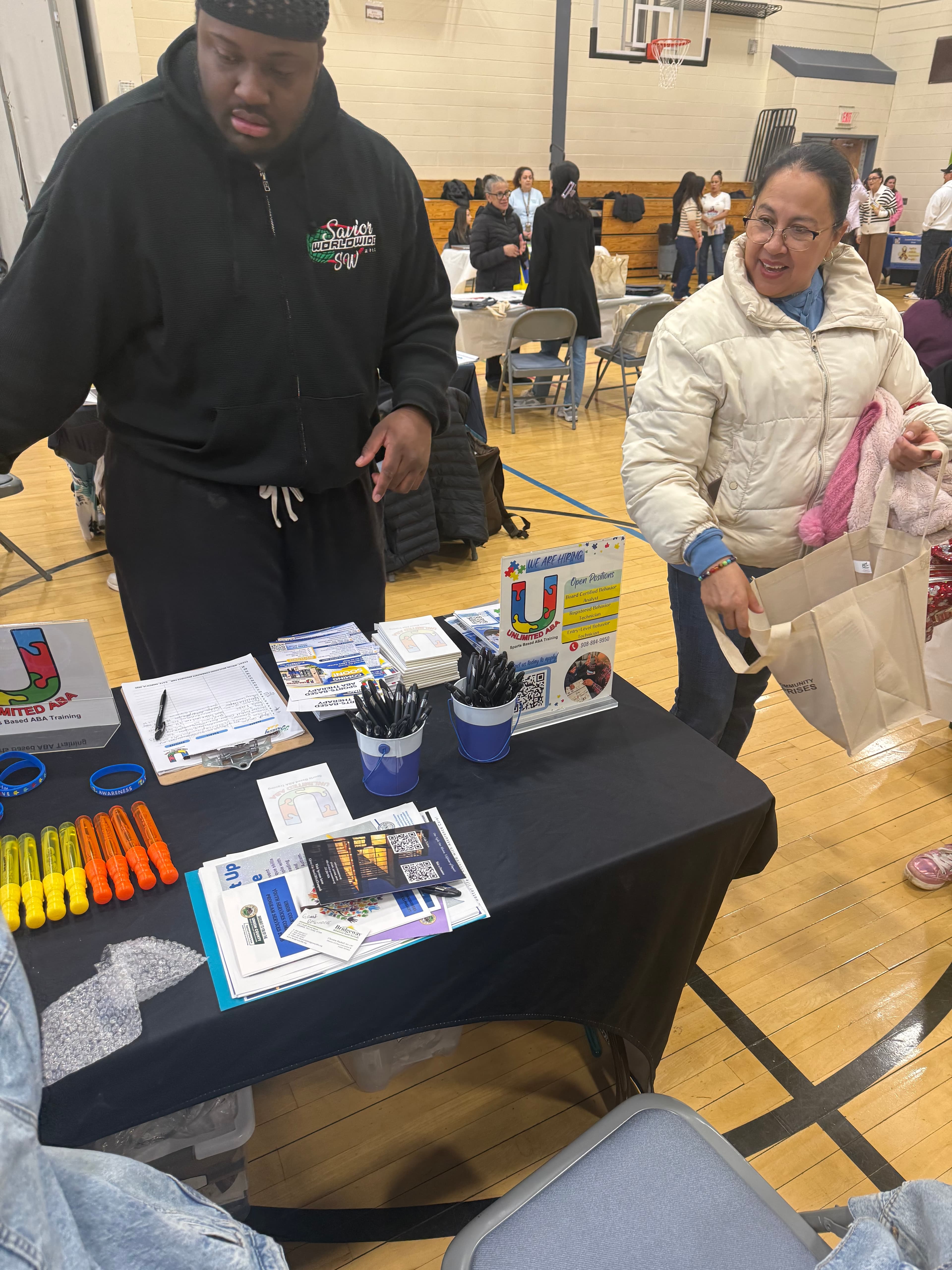 Basim Hudeen connecting one-on-one with a parent at a community outreach event